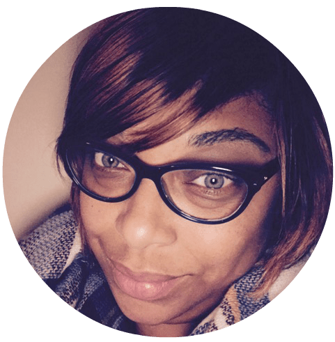 A photo of Shannon Boone, Sesi's art director, emeritus. She's a Black woman wearing short hair and black glasses.