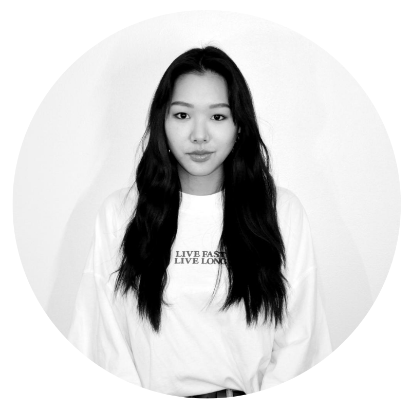 Team Sesi. Black and white headshot of Cass Yu, contributing layout designer. She's an Asian woman wearing her hair long. She's got on a white sweatshirt that says, "Live Fast, Live Long."