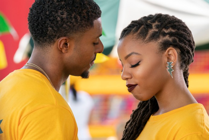 Diggy Simmons and Chloe Bailey facing each other wearing yellow t-shirts on the set of Grown-ish