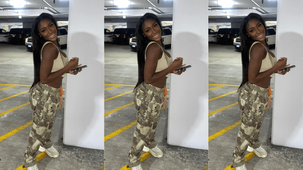 Lauren Smith-Fields smiling as her photo is taken in a parking garage