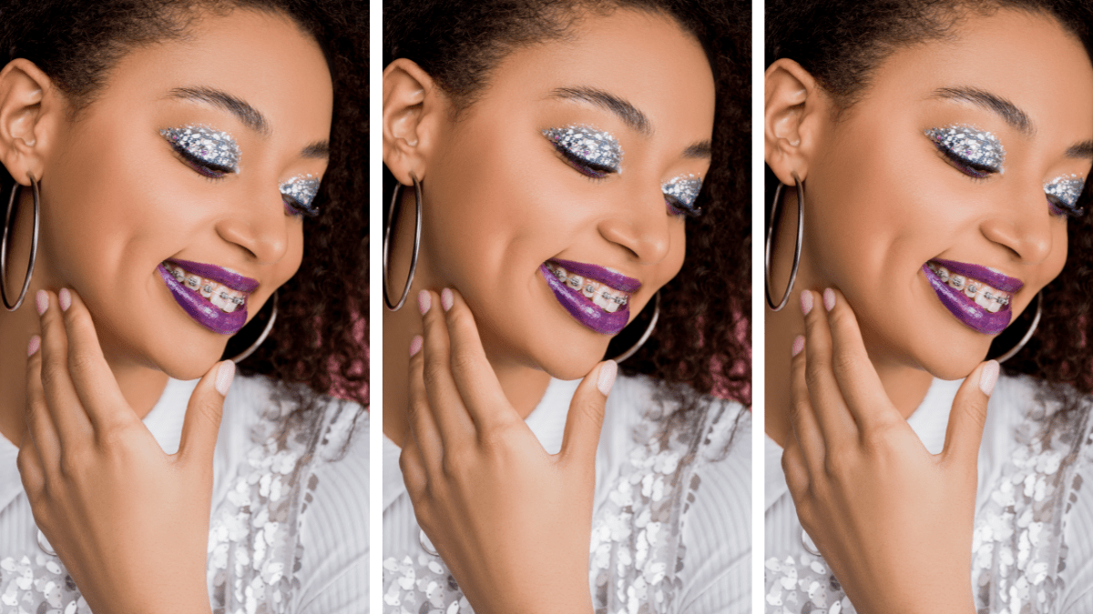 cheerful african-american teen girl with silver glitter eyeshadows and purple lips wearing paillettes dress